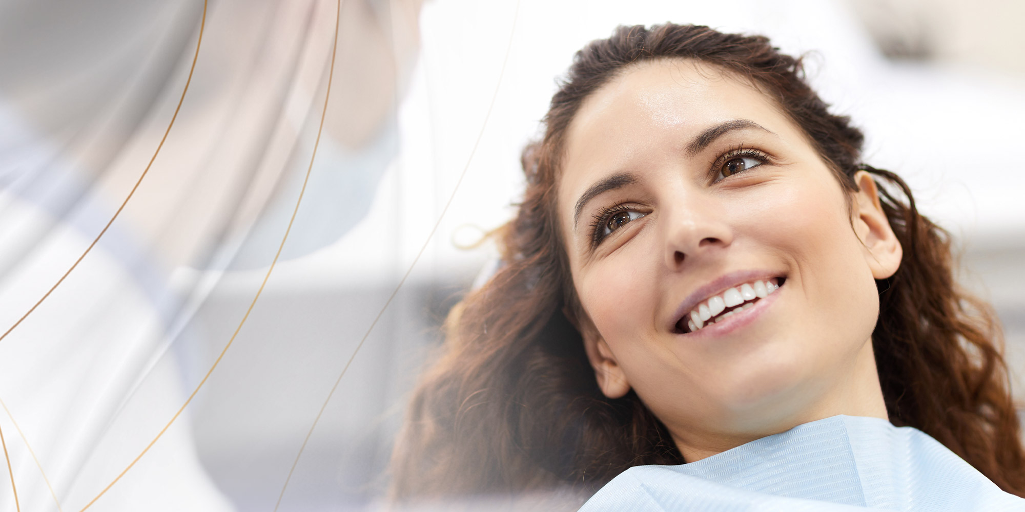 Lady with dark hair smiling looking at doctor at Restore Denture and Implant Center